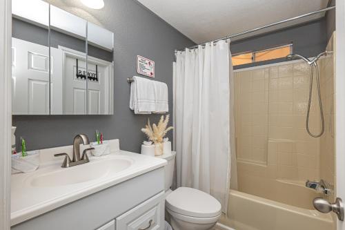 a bathroom with a sink and a toilet and a shower at Mountain Views minutes from casinos and Lake in Bullhead City