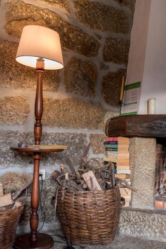 a lamp sitting next to a basket of books at Casa da Torre, Porto Manso in Riba Douro