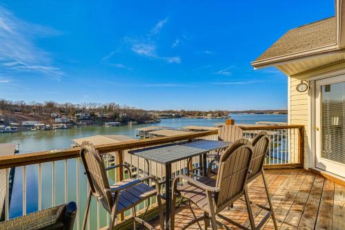 a balcony with tables and chairs and a view of the water at Osage Beach Condo Boat Slip and Pool Access! in Osage Beach
