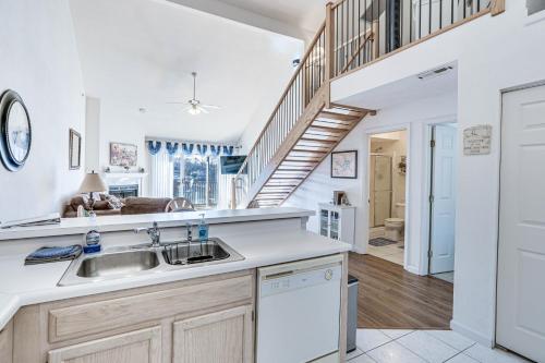 a kitchen with a sink and a staircase at Osage Beach Condo Boat Slip and Pool Access! in Osage Beach