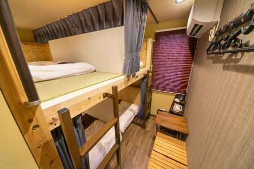 a room with two bunk beds and a window at IKIDANE Cozy Hotel Haneda Airport - Vacation STAY 25827v in Tokyo