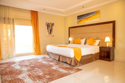 a bedroom with a large bed and a large window at Suite 777 in Jeddah