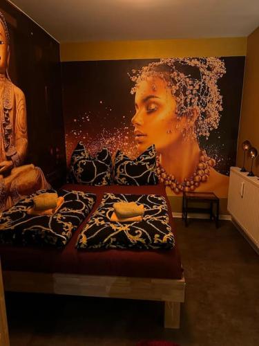 a bed with a painting of a woman on the wall at Luxurious Apartment with Sauna in Cologne