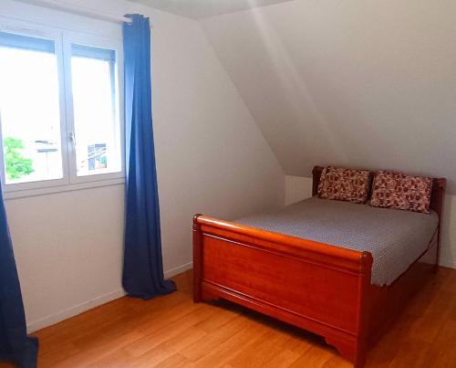 a small bedroom with a bed and a window at Charming house near the sea in Courseulles-sur-Mer