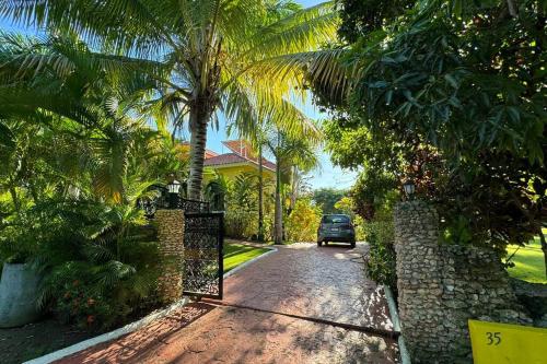a car driving down a road in front of a house at Private Pool Villa - BBQ - Washer in Sosúa