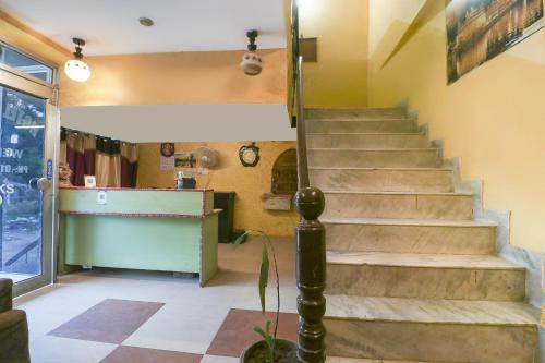 a staircase in a room with a counter and a stair case at OYO Hotel Star Inn in Sohāna