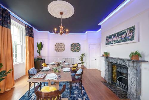 a dining room with a table and a fireplace at The Steam House - 3 Bedroom Townhouse in Bath by Mint Stays in Bath