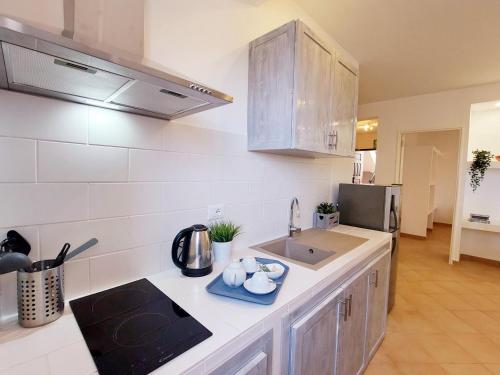 a kitchen with a sink and a counter top at Branco Sea Holiday Apartments in Santa Maria