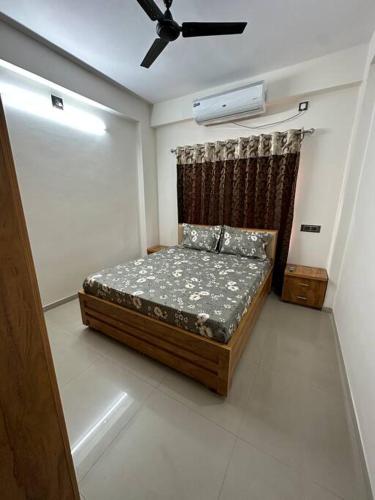 a bedroom with a bed and a ceiling fan at Brand new Entire 2BHK Apartment with WFH space. in Ahmedabad