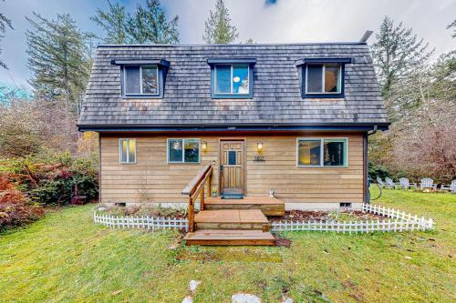 a tiny house with a staircase in the yard at Dogwood Place in Johnson Landing