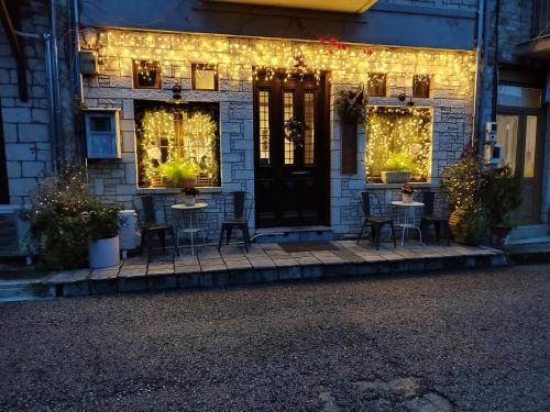 a house with lights on the front of it at Roptro in Doliana