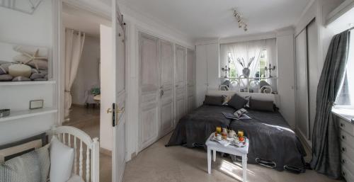 a bedroom with a bed and a table with bottles on it at Villa spa hamman sauna Piscine 9 chambres in Juan-les-Pins