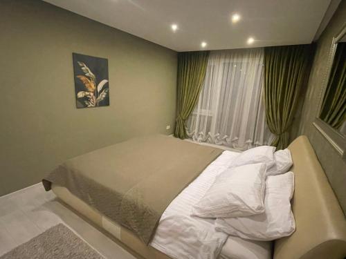 a bedroom with a bed and a window at Apartment in Šiauliai in Šiauliai