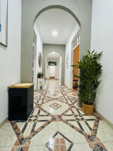 a hallway with a tile floor and an archway at Isor Triana in Las Palmas de Gran Canaria