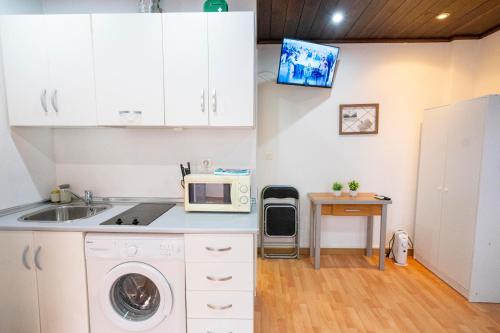 a kitchen with a sink and a microwave at Carmen Aljibe de la Miel in Granada