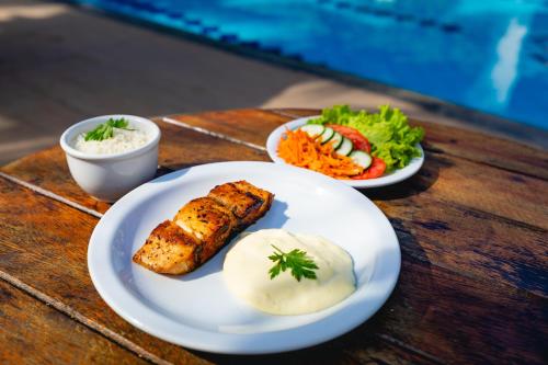 a table with two plates of food on a table at Arraial do Sol Beach Hotel in Arraial d'Ajuda