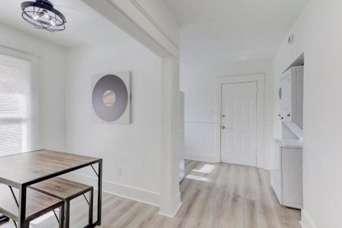 a white room with a table and a hallway at Heart of Cooper Young in Memphis