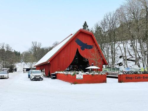 a red barn with a bird on the side of it at 4 person holiday home in TRENSUM-By Traum in Trensum