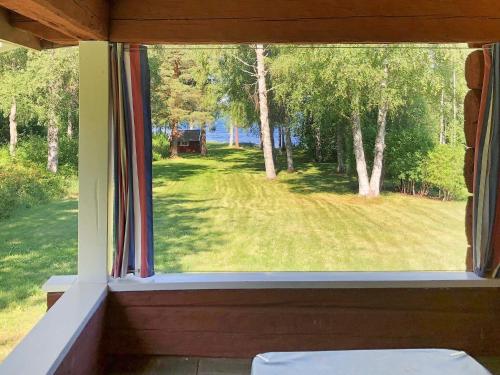 a window in a house with a view of a yard at 6 person holiday home in RÄTTVIK-By Traum in Rättvik
