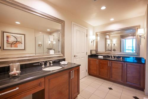 a bathroom with a sink and a large mirror at Jet Luxury Elite at The Signature in Las Vegas