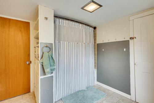 a walk in closet with a shower curtain and a door at Quiet Port Royal Home with Deck, Near Juniata River! in Mifflintown