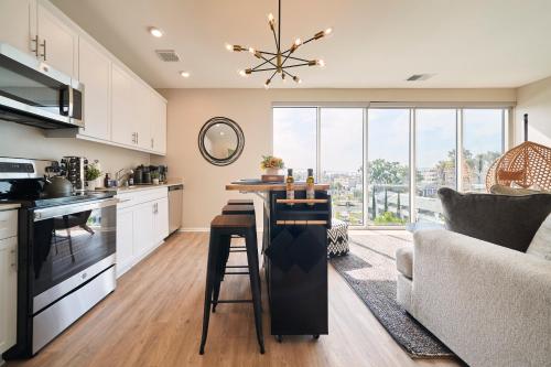 a kitchen with a table and a living room at NEW Organic Modern Luxury 1BD/1BA- close to everything! in San Diego