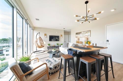 a kitchen and living room with a table and chairs at NEW Organic Modern Luxury 1BD/1BA- close to everything! in San Diego