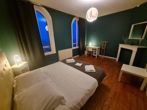 une chambre avec un lit blanc avec deux serviettes dessus dans l'établissement La Tour L'évêque gite 3 chambres 5 pers 5 km Soissons, à Septmonts