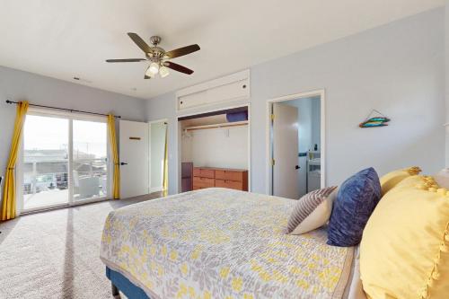 a bedroom with a bed and a ceiling fan at This Is It in Crescent City