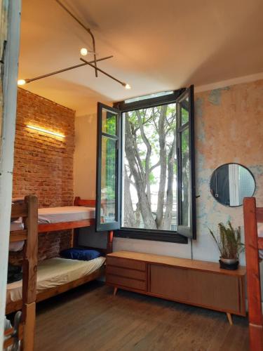 Una habitación con una ventana con un árbol. en Casa Mutante en Montevideo