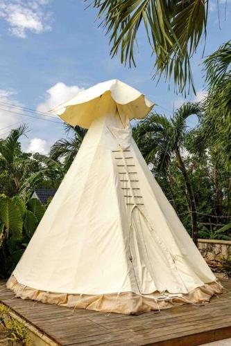 a statue of a boat with an umbrella at The Oasis Tulum Luxury Front Beach Villa 8 Rooms in Tankah