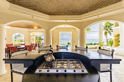 a kitchen with a stove top in a living room at The Oasis Tulum Luxury Front Beach Villa 8 Rooms in Tankah