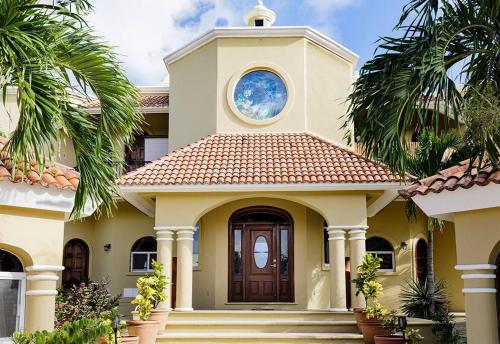 a house with a clock tower on top of it at The Oasis Tulum Luxury Front Beach Villa 8 Rooms in Tankah