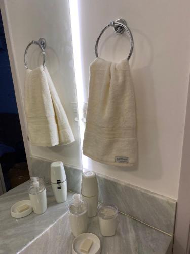 a bathroom with towels hanging on a wall at Estilo Itacaré in Itacaré