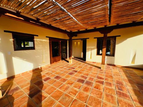 ein leeres Zimmer mit Backsteinboden und Holzdecke in der Unterkunft Hermosa Cabaña Campestre el Palmar in Villa de Leyva