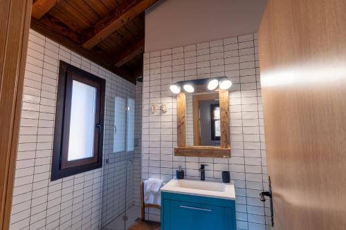 a bathroom with a sink and a mirror at Arpetxea casa rural in Roncal