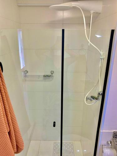 a shower with a glass door in a bathroom at Studio Vertentes in Sao Paulo