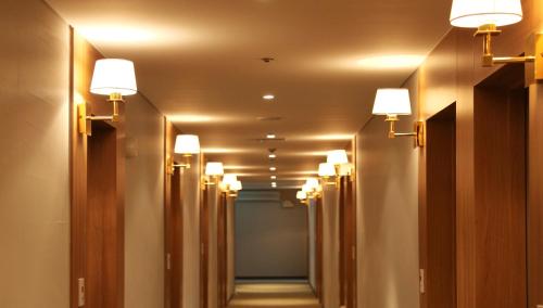 a hallway with a row of lights on the ceiling at Hotel Skypark Myeongdong 1 in Seoul