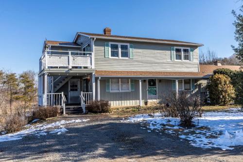 a house with a porch and a balcony at The Loft at Hebron Valley Overlook in Madison