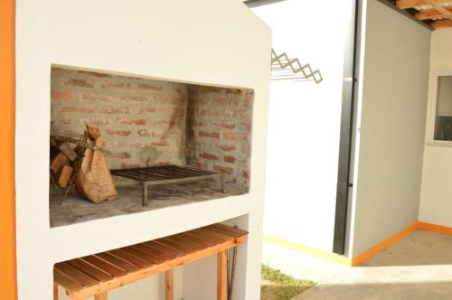 a fireplace in a house with a brick wall at SUEÑOS DE TERMAS in Chajarí