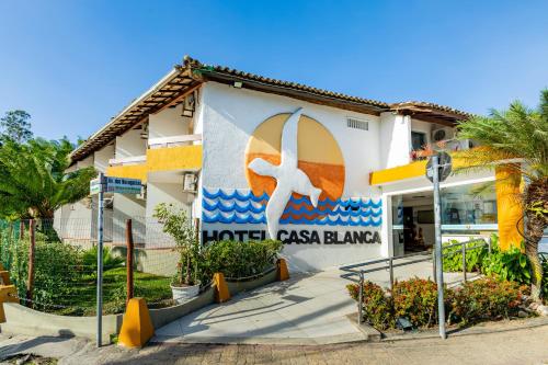a building with a sign on the side of it at Hotel Casa Blanca Porto Seguro in Porto Seguro