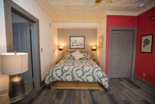 a bedroom with a bed and a red wall at Dodici Night Suites in Washington