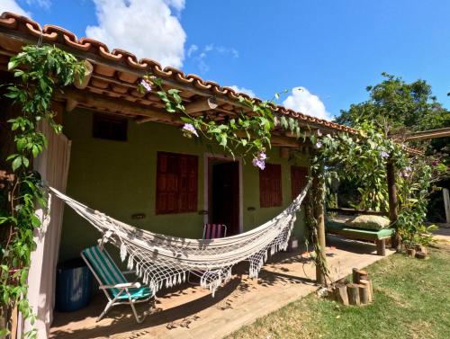 a house with a hammock outside of it at Res. Orion Praia do Espelho in Praia do Espelho