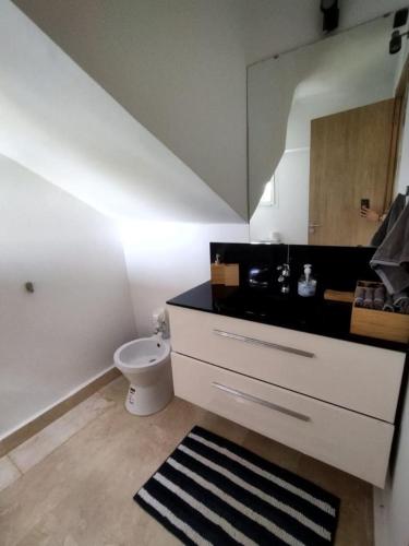 a bathroom with a toilet and a sink and a mirror at villa star hill Tanger in Tangier