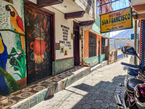 a street with a motorcycle parked in front of a building at Hotel San Francisco in San Pedro La Laguna