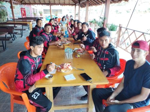 a group of people sitting at a table eating food at Hotel Angostura in Cochabamba