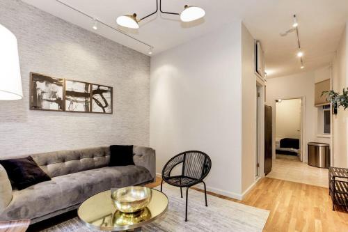a living room with a couch and a table at Apartment 129: Upper East Side in New York