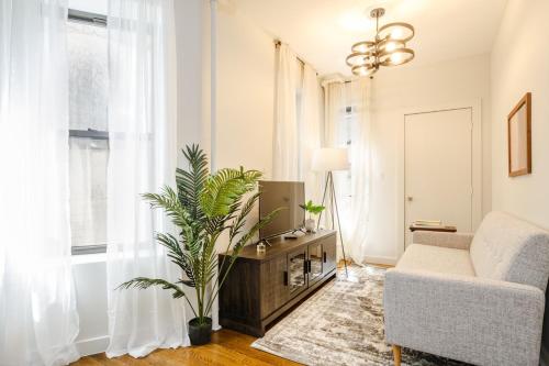 a living room with a couch and a tv at Apartment 235: Lower East Side in New York
