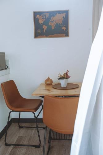 a table and chairs in a room with a table and a table and a table at Natura Bungalows in Fortuna