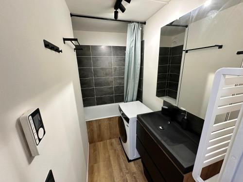 a bathroom with a sink and a toilet and a mirror at Studio Corrençon-en-Vercors, 1 pièce, 4 personnes - FR-1-515-204 in Corrençon-en-Vercors